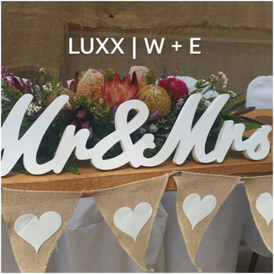Rustic floral arrangement on bridal table by Luxx Weddings & Events. Australia's elite event stylist.